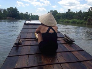 My daughter riding a sampan on the Mekong